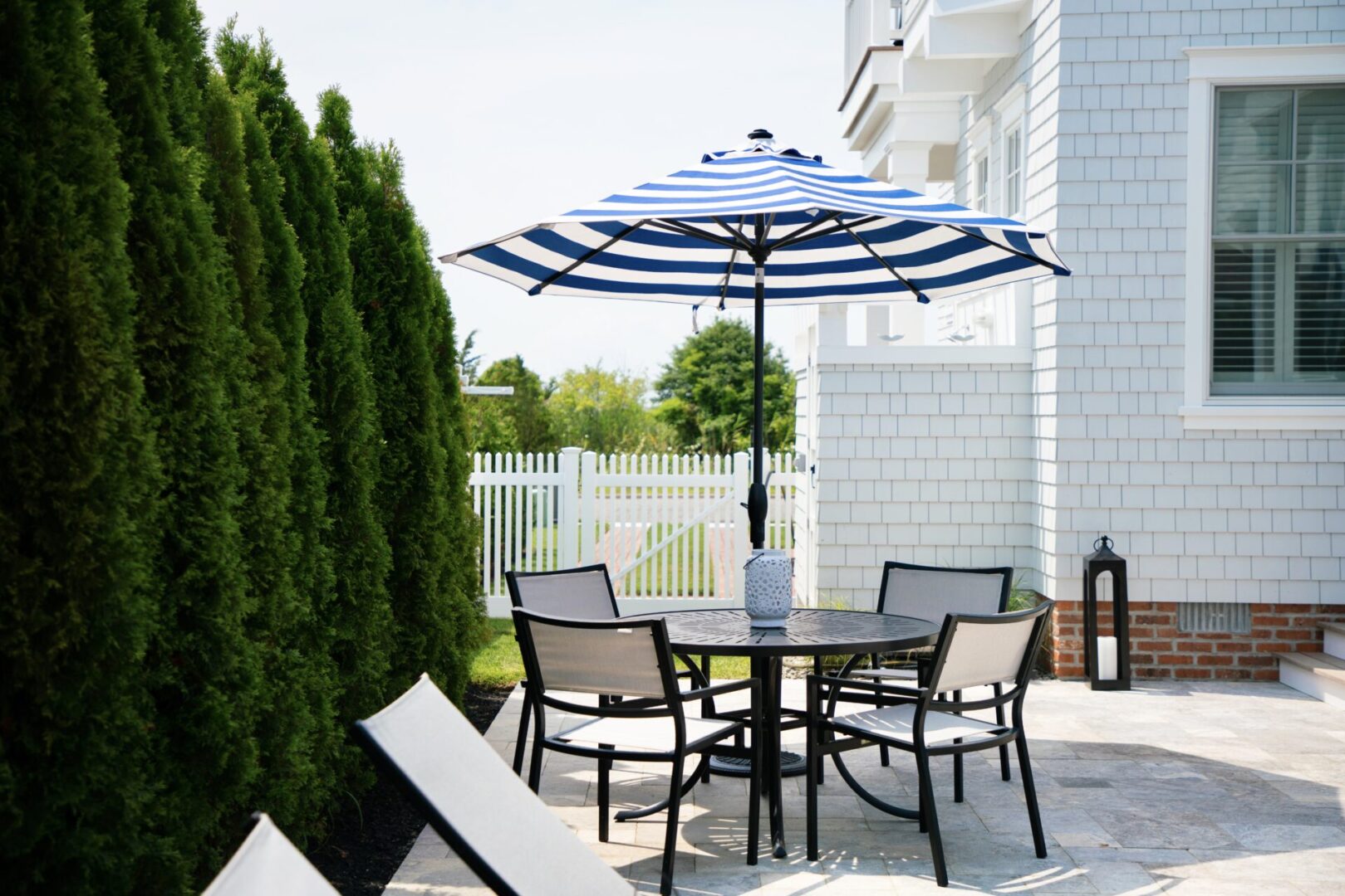 A table with an umbrella and four seats