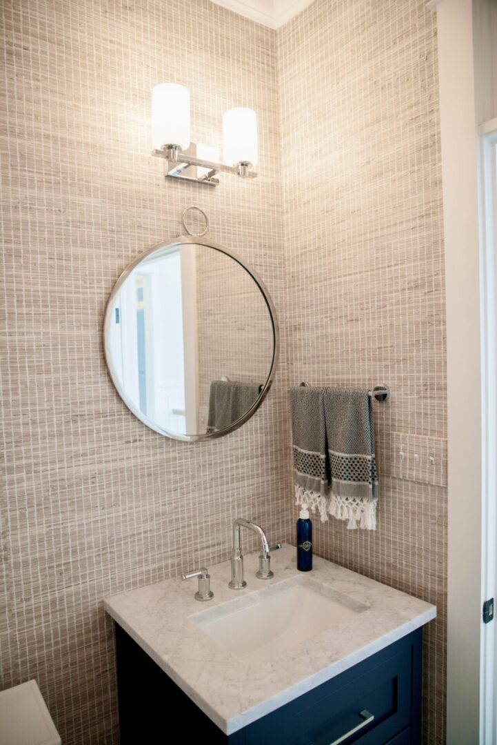 A bathroom vanity with a wall lamp